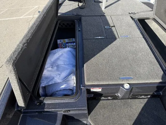 Slide: The Image of 2024 Bass Cat Puma STS interior with gray seating and sleek flooring. - 14