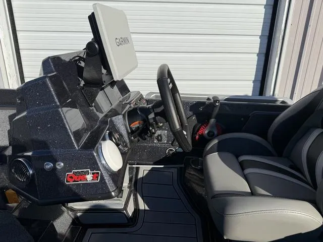 Slide: The Image of 2024 Bass Cat Puma STS boat storage compartments with logo, featuring sleek design and seating. - 20