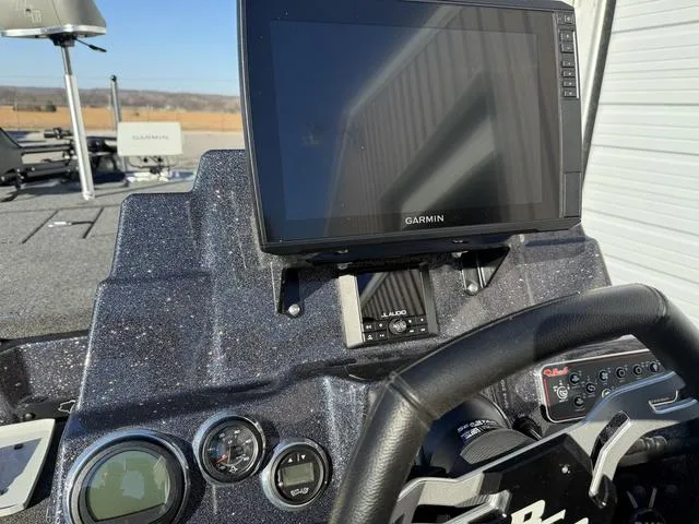 Slide: The Image of 2024 Bass Cat Puma STS dashboard with Garmin display and controls. - 25