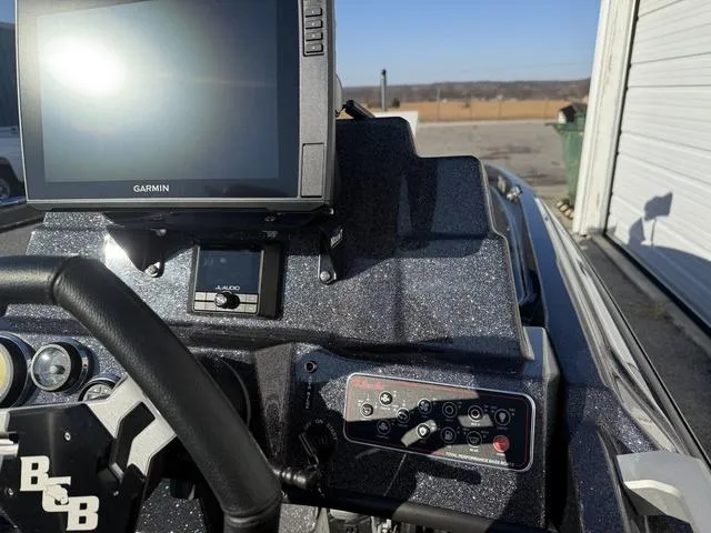 Slide: The Image of 2024 Bass Cat Puma STS dashboard with Garmin display and control panel. - 26