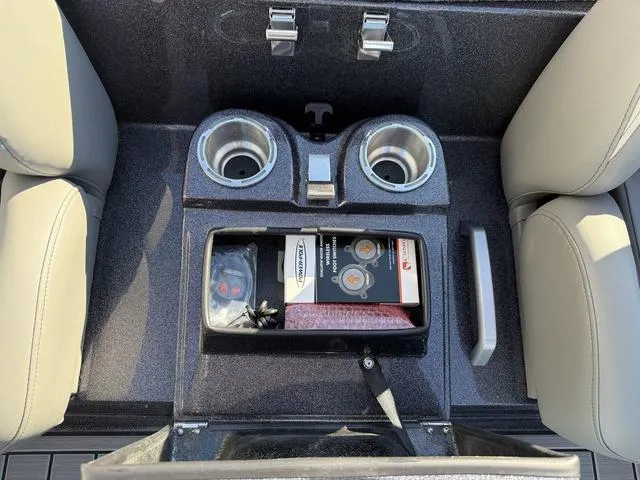 Slide: The Image of 2024 Bass Cat Puma STS interior console with cup holders and storage compartment. - 28