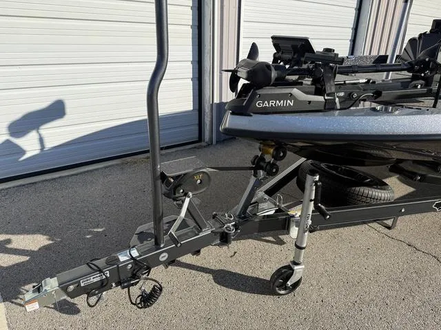 Slide: The Image of 2024 Bass Cat Puma STS boat on trailer, showcasing sleek black hull design. - 7