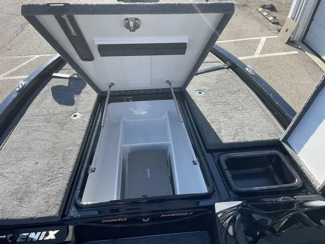 Slide: The Image of 2024 Phoenix 920 Elite boat storage compartment open, showcasing spacious interior design. - 12