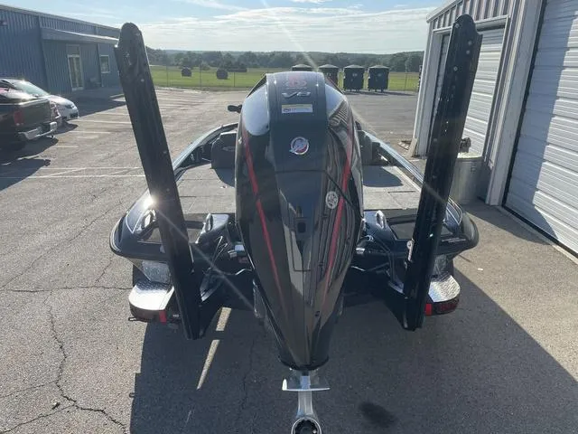 Slide: The Image of 2024 Phoenix 920 Elite boat with powerful engine, parked outdoors. - 13