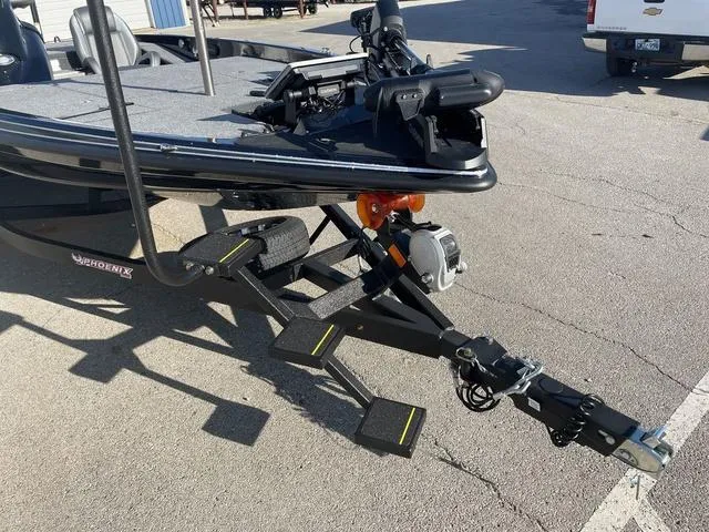 Slide: The Image of 2024 Phoenix 920 Elite boat trailer with steps and hitch in parking lot. - 5