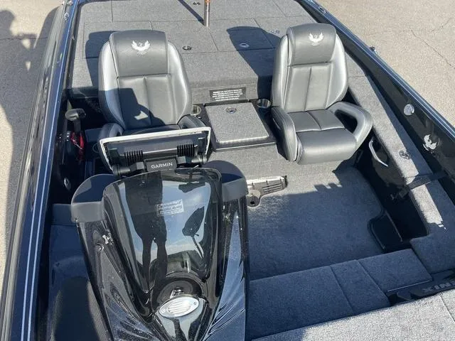 Slide: The Image of 2024 Phoenix 920 Elite boat interior with two gray seats and Garmin equipment. - 7