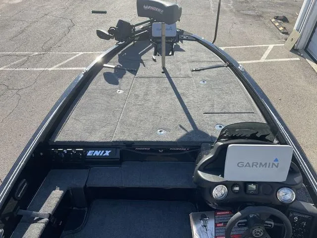 Slide: The Image of 2024 Phoenix 920 Elite boat with Garmin navigation system, spacious deck, and modern controls. - 8