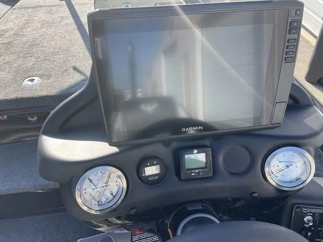 Slide: The Image of 2024 Phoenix 920 Elite dashboard with Garmin display and gauges. - 9