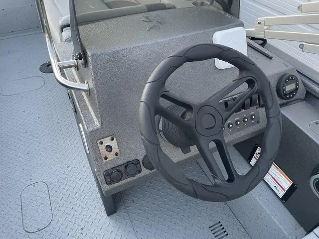 Slide: The Image of 2024 SeaArk Easy 200 boat steering console with modern controls and textured flooring. - 12