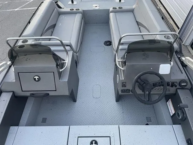 Slide: The Image of 2024 SeaArk Easy 200 boat interior with dual consoles and seating. - 14