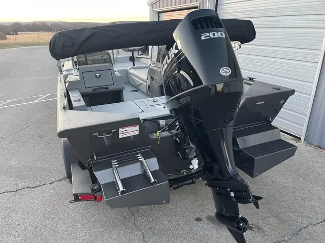 Slide: The Image of 2024 SeaArk Easy 200 boat with Suzuki 200 engine, parked near a garage. - 3