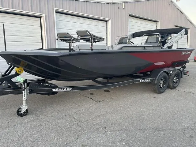 Slide: The Image of 2024 SeaArk Easy 200 boat on trailer, parked outside a garage. - 4
