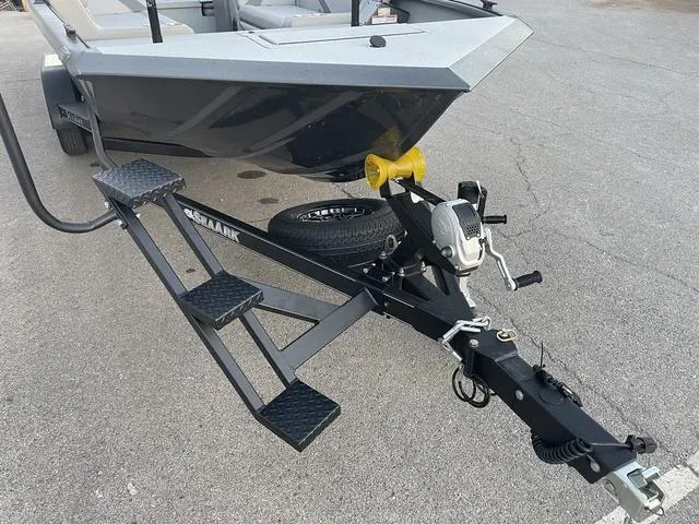 Slide: The Image of 2024 SeaArk Easy 200 boat on trailer, featuring sturdy black frame and steps. - 5