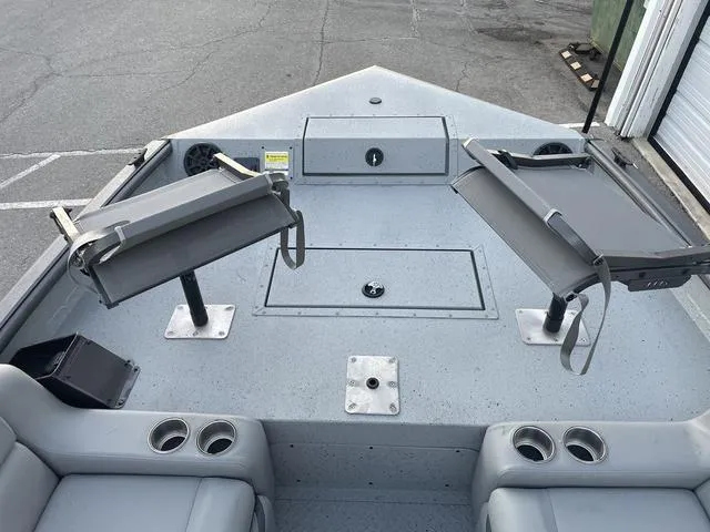 Slide: The Image of 2024 SeaArk Easy 200 boat interior with seating and storage compartments. - 7