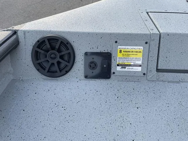 Slide: The Image of 2024 SeaArk Easy 200 boat interior with speaker and capacity label. - 8