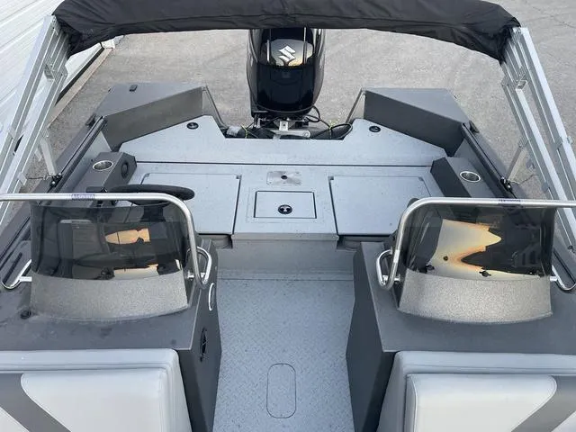 Slide: The Image of 2024 SeaArk Easy 200 boat interior with dual consoles and outboard motor. - 9