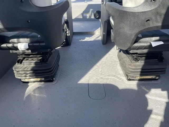 Slide: The Image of Interior of 2025 SeaArk Pro Cat 240 boat showing seating and flooring. - 11