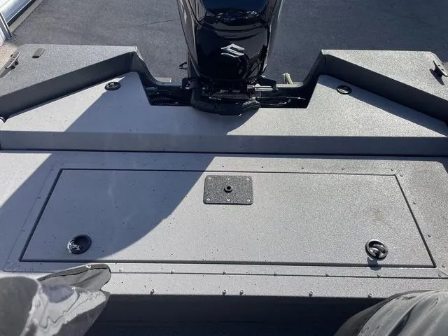 Slide: The Image of 2025 SeaArk Pro Cat 240 boat deck with Suzuki motor, featuring storage compartment. - 16