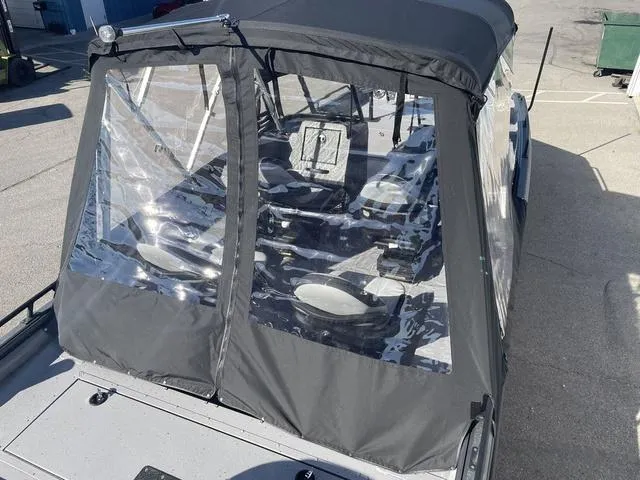 Slide: The Image of 2025 SeaArk Pro Cat 240 boat with protective canopy and clear windows. - 17