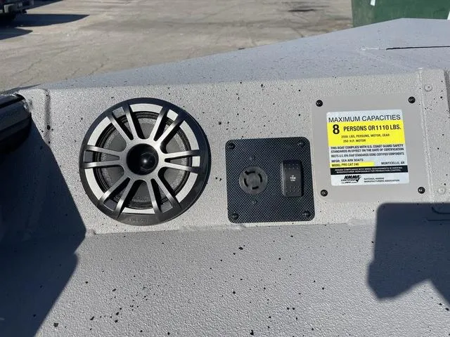 Slide: The Image of SeaArk Pro Cat 240 boat dashboard with speaker and capacity label, 2025 model. - 7