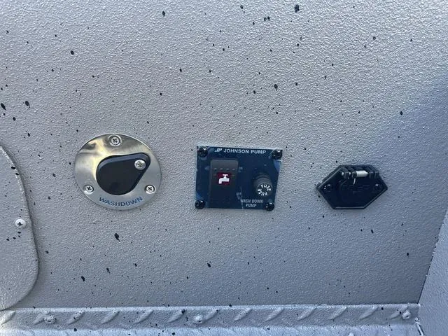 Slide: The Image of Close-up of 2025 SeaArk Pro Cat 240 boat controls and washdown panel. - 8