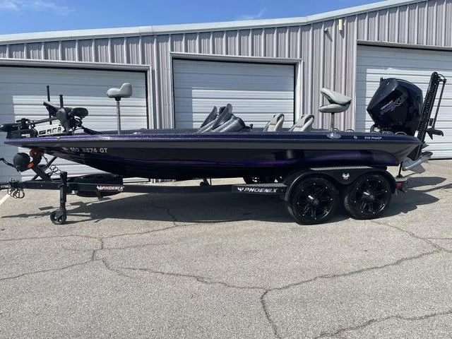Slide: The Image of 2022 Phoenix 919 Pro XP boat parked outside storage units. - 1
