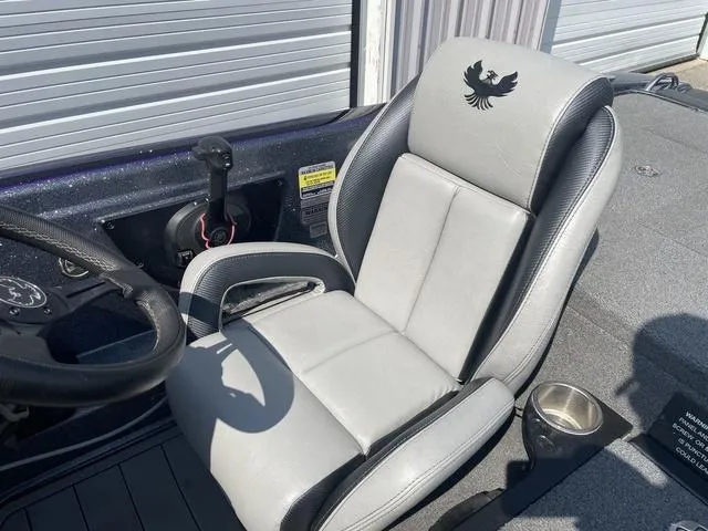 Slide: The Image of 2022 Phoenix 919 Pro XP boat seat with logo, steering wheel, and cup holder. - 16