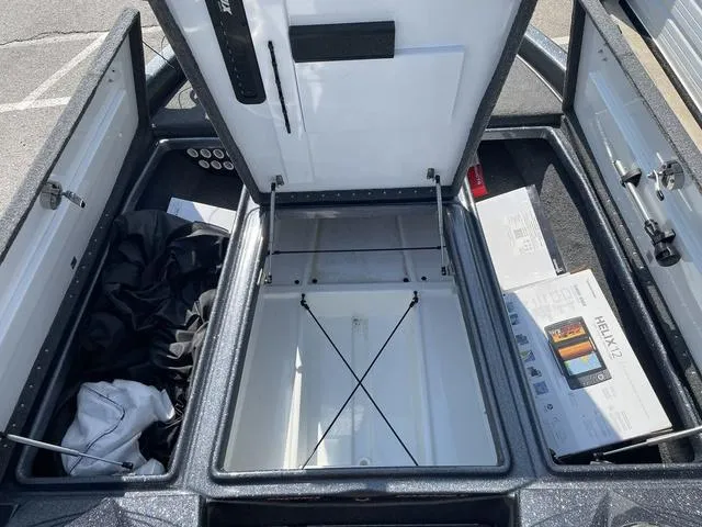 Slide: The Image of Open storage compartment of 2022 Phoenix 919 Pro XP boat with accessories. - 18