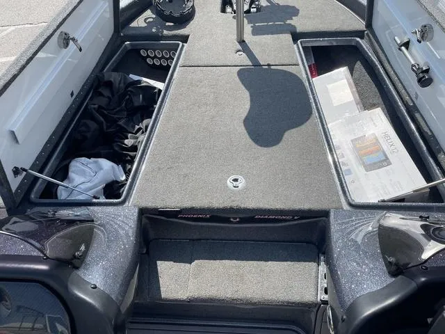 Slide: The Image of 2022 Phoenix 919 Pro XP boat interior with storage compartments open. - 19