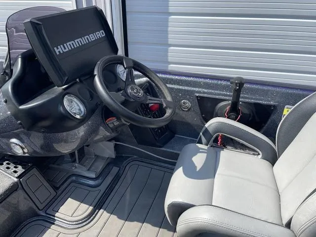 Slide: The Image of 2022 Phoenix 919 Pro XP boat cockpit with Humminbird electronics and steering wheel. - 21