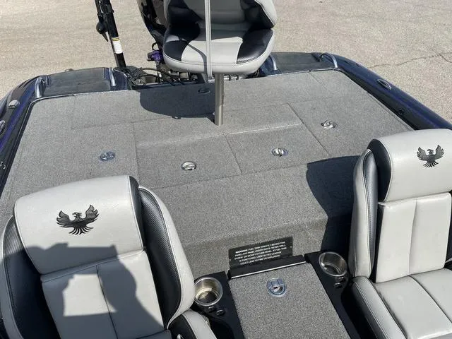 Slide: The Image of 2022 Phoenix 919 Pro XP boat interior with gray seating and storage compartments. - 23