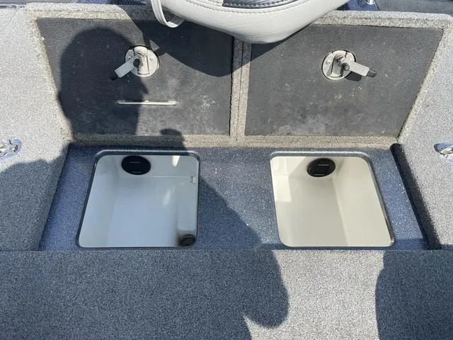 Slide: The Image of 2022 Phoenix 919 Pro XP boat storage compartments with secure latches. - 24