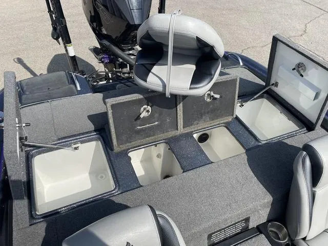 Slide: The Image of 2022 Phoenix 919 Pro XP boat with open storage compartments and seating. - 25