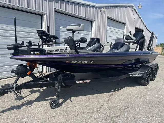 Slide: The Image of 2022 Phoenix 919 Pro XP fishing boat on trailer, parked outside storage units. - 4