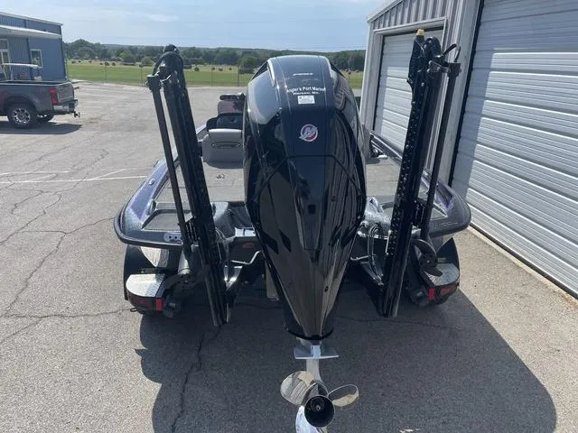 Slide: The Image of 2022 Phoenix 919 Pro XP boat with powerful outboard motor in a parking area. - 6