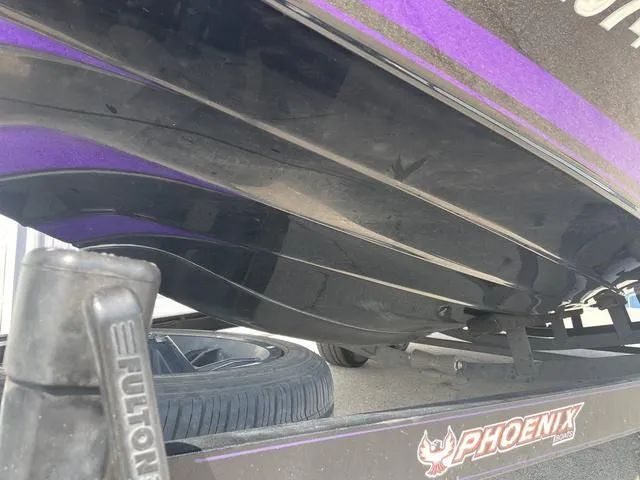 Slide: The Image of 2022 Phoenix 919 Pro XP boat hull with trailer, featuring sleek black and purple design. - 8