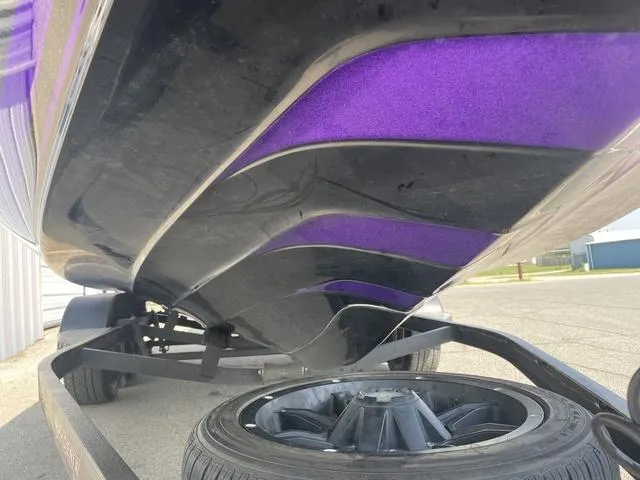 Slide: The Image of Close-up of 2022 Phoenix 919 Pro XP boat hull with purple and black design. - 9