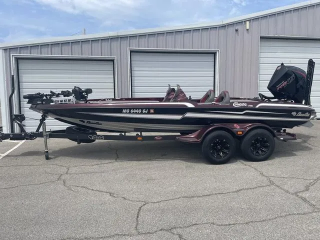 Slide: The Image of 2020 Bass Cat Cougar FTD boat parked outside a garage. - 1
