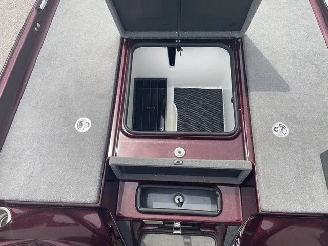 Slide: The Image of 2020 Bass Cat Cougar FTD boat storage compartments, open and closed, with carpeted surfaces. - 13