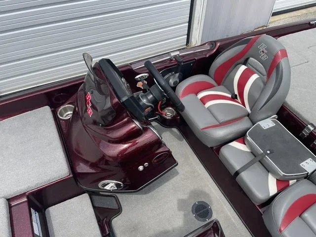 Slide: The Image of 2020 Bass Cat Cougar FTD boat interior with red and gray seating, steering console, and storage compartments. - 15