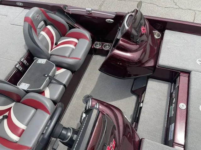 Slide: The Image of 2020 Bass Cat Cougar FTD boat interior with red and gray seats, dual consoles, and storage compartments. - 16