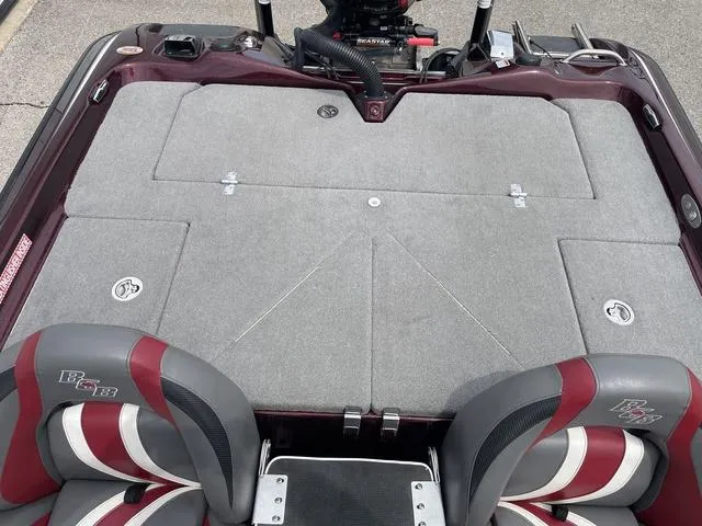 Slide: The Image of 2020 Bass Cat Cougar FTD boat interior with gray deck and red-accented seats. - 20