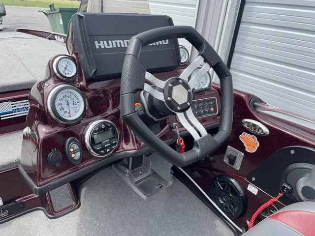 Slide: The Image of 2020 Bass Cat Cougar FTD boat dashboard with steering wheel and gauges. - 29