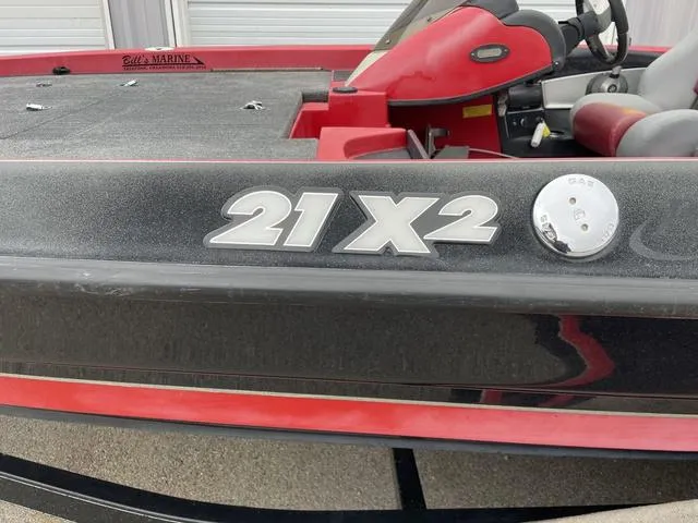 Slide: The Image of 2007 Triton 21 X2 boat, red and black exterior, close-up view. - 10