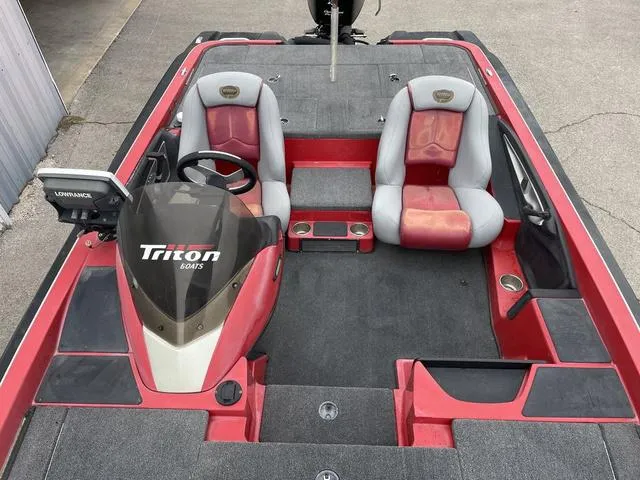 Slide: The Image of 2007 Triton 21 X2 boat interior with red and gray seating, steering console, and Lowrance electronics. - 15