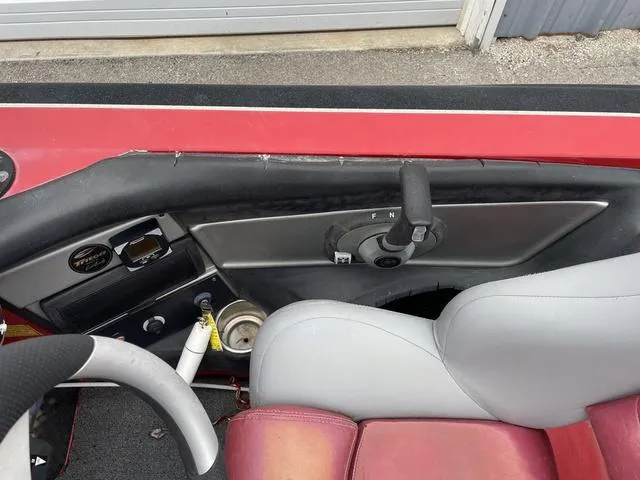 Slide: The Image of Interior of a 2007 Triton 21 X2 boat with red and gray seating. - 18