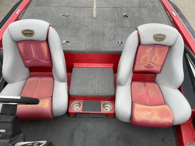 Slide: The Image of 2007 Triton 21 X2 boat interior with red and gray seats, cup holders, and carpeted deck. - 19