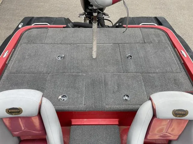 Slide: The Image of 2007 Triton 21 X2 boat interior with gray carpet and red accents. - 21