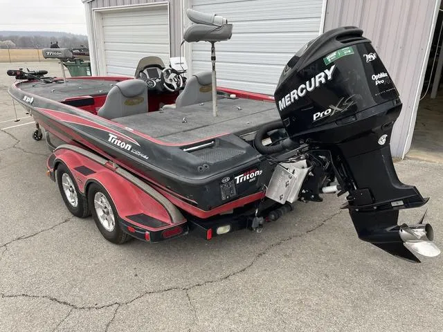 Slide: The Image of 2007 Triton 21 X2 boat with Mercury Pro XS engine, parked near a garage. - 3