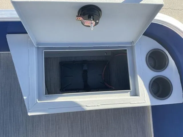 Slide: The Image of 2023 Lowe Ultra 182 Fish & Cruise boat storage compartment with cup holders. - 12